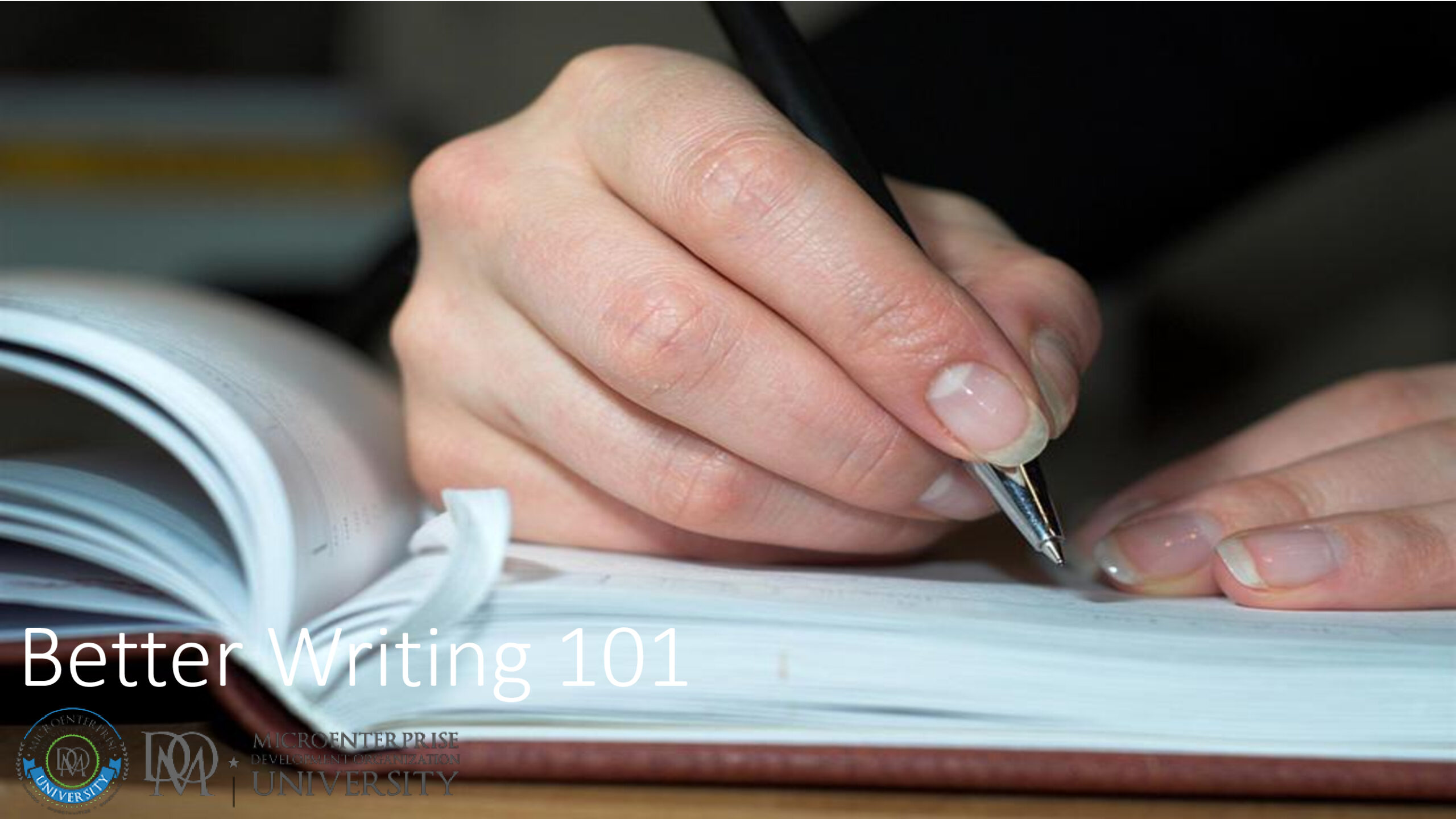 Hand writing with pen in open notebook