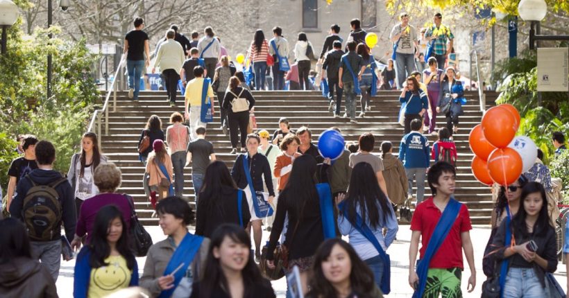 Busy university steps filled with students and balloons