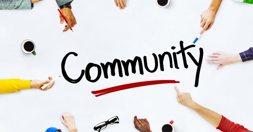 Multiple hands around "Community" word