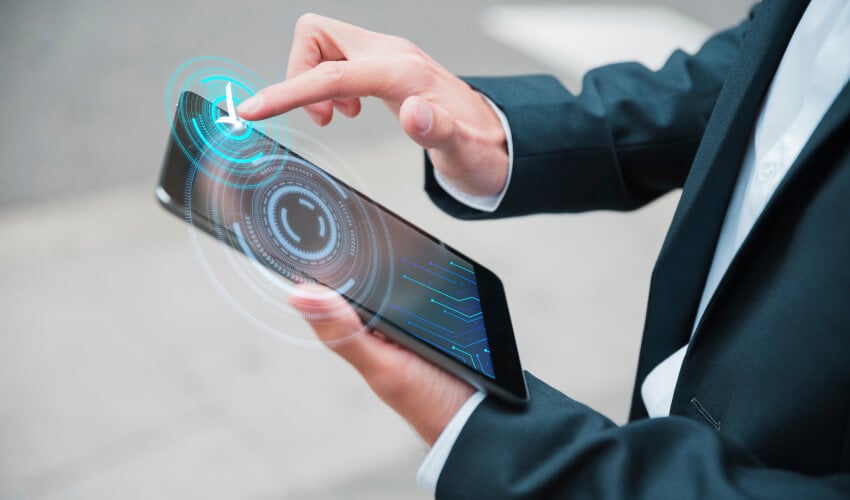 Businessperson touching tablet with holographic interface