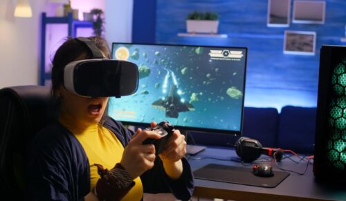 Gamer wearing VR headset playing space game