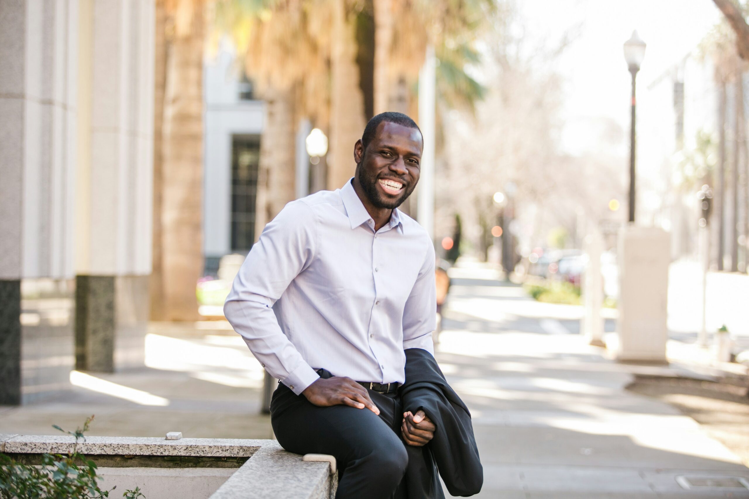 Smiling man in business casual outdoors