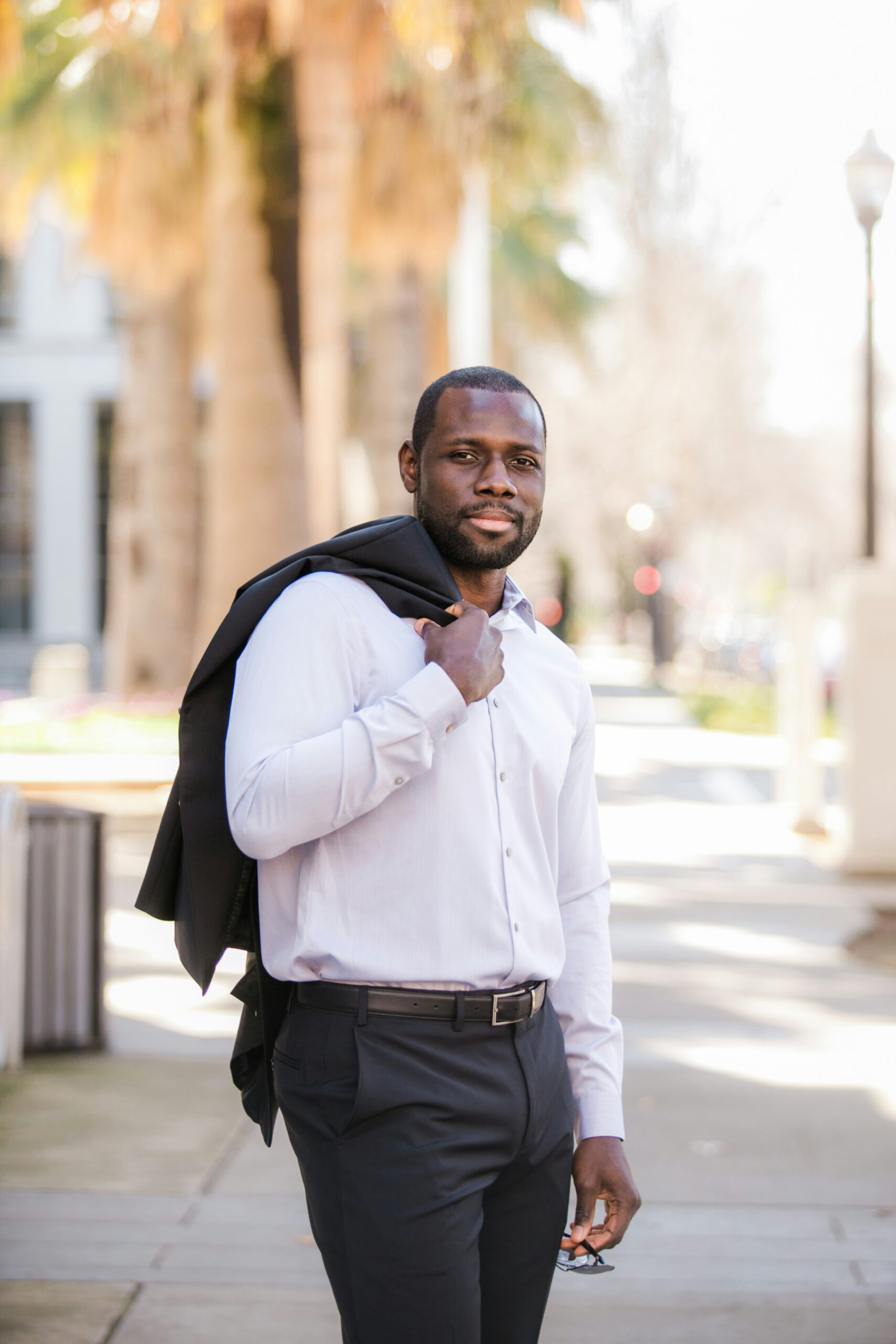 Professional man carrying jacket over shoulder