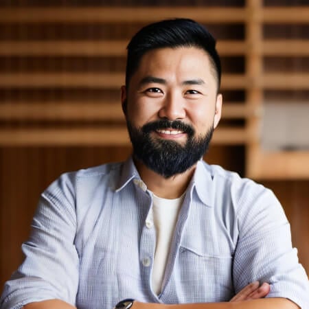 Smiling bearded man with crossed arms