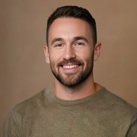 Smiling bearded man in olive sweater