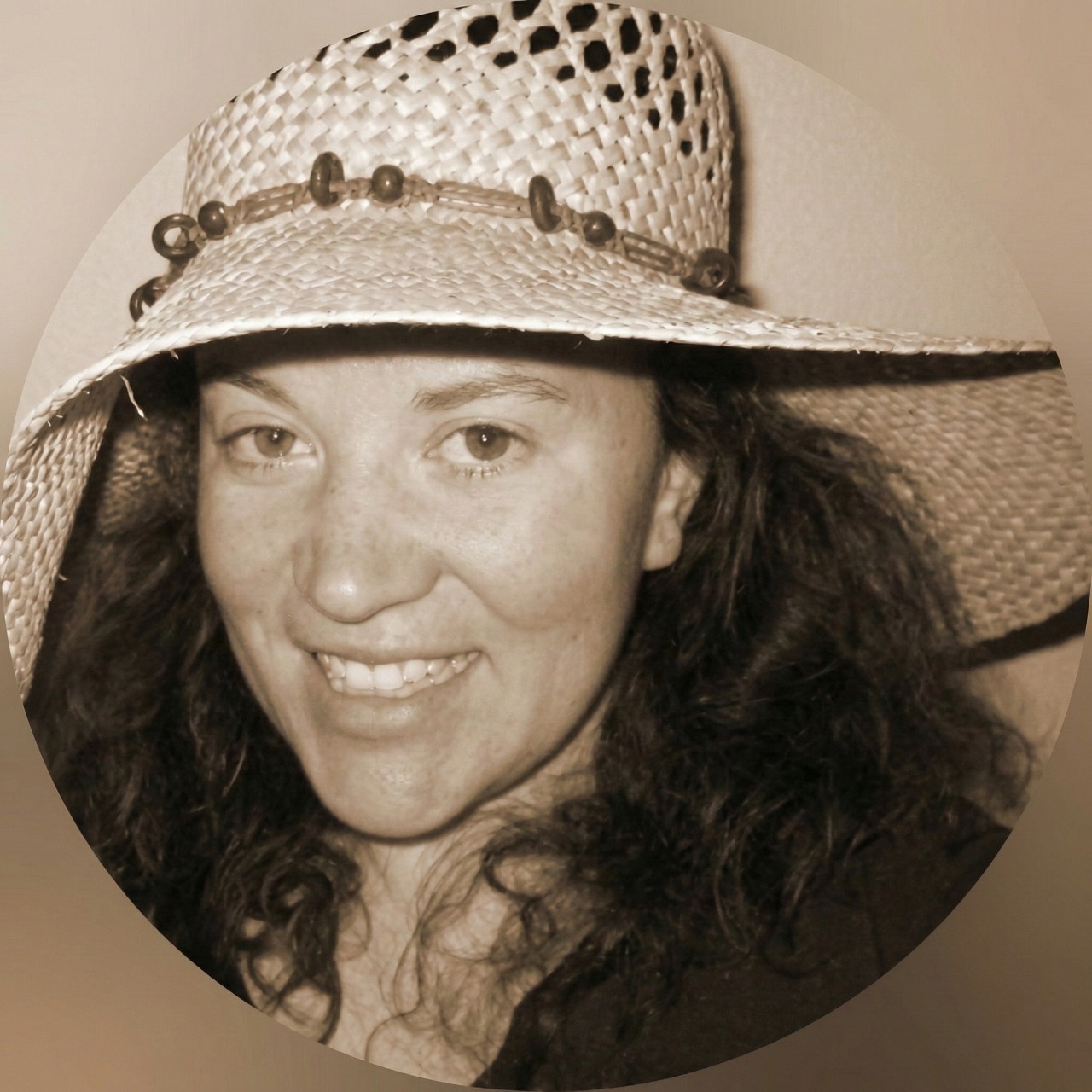 Sepia portrait of smiling woman in straw hat